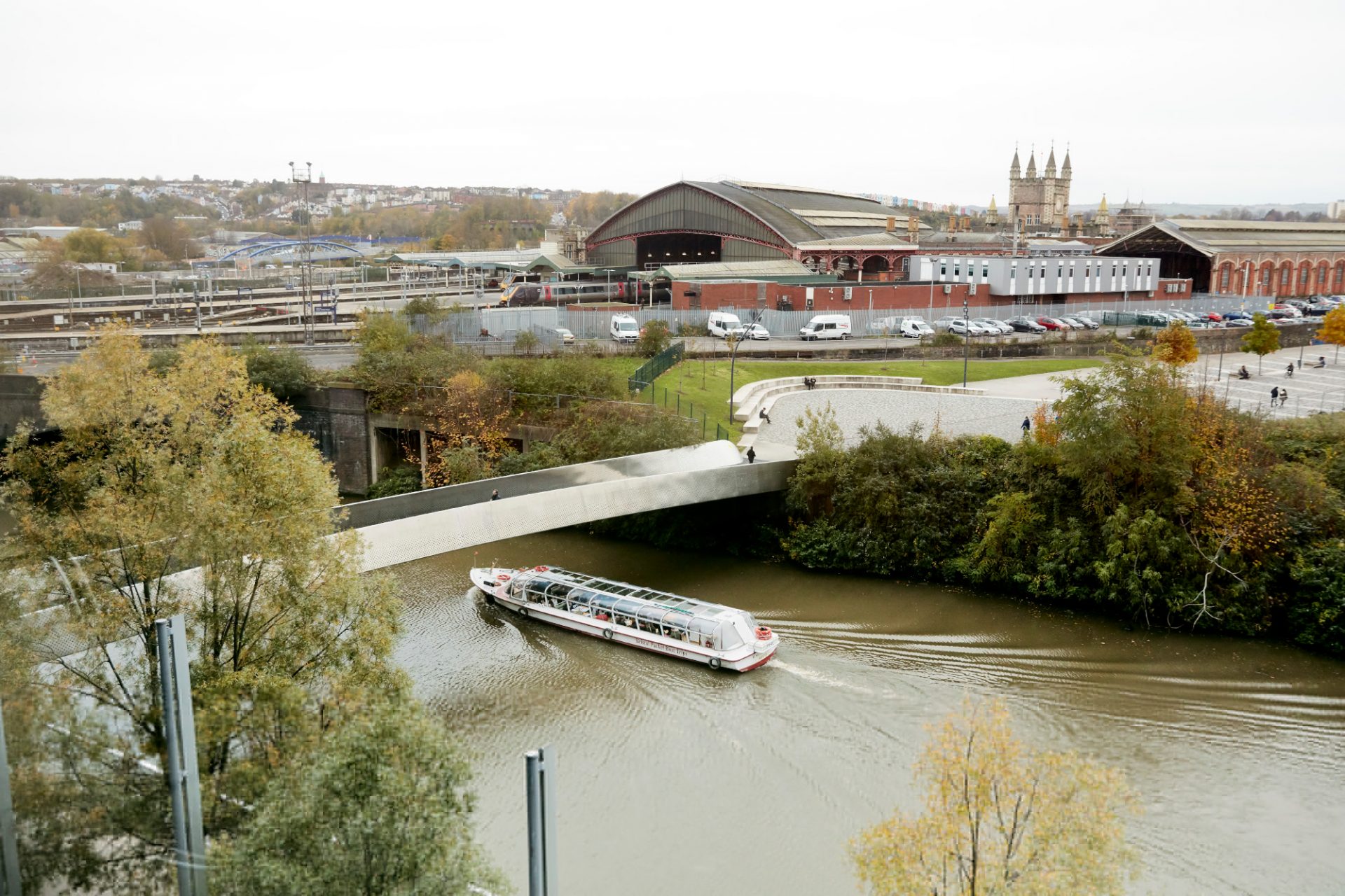 Canal boat sailing underneath a bridge