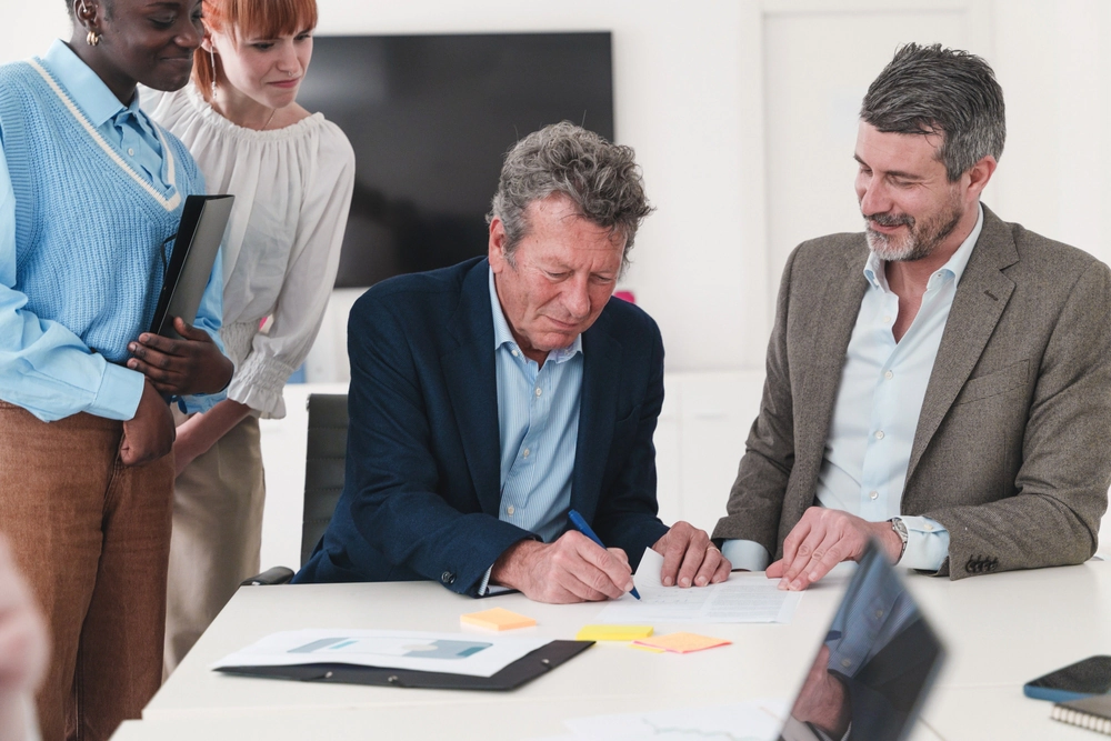 Business team signing document.