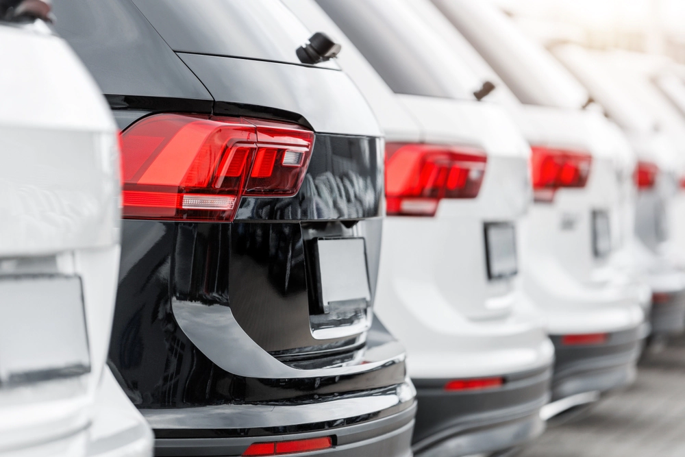 Suvs in a row at a car dealership.