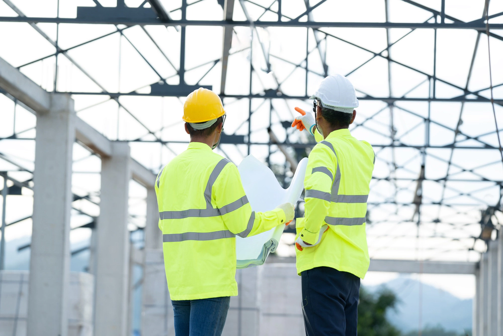 Two construction workers reviewing a project.